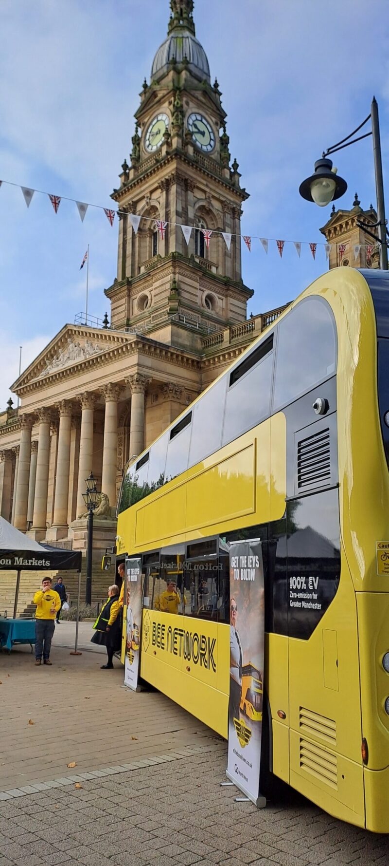 YELLOW BUS IN FRONT OF BOLTON TOWN HALL
